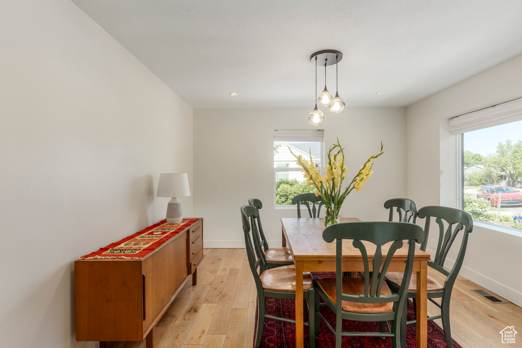 Dining area featuring light wood-style flooring, baseboards, and recessed lighting