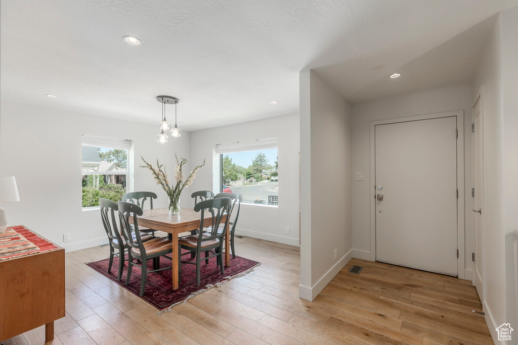 Dining area featuring light wood-style floors, baseboards, and recessed lighting