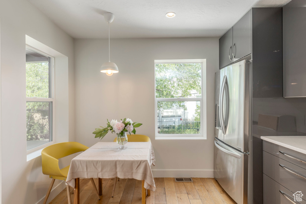 Dining area featuring baseboards, light wood-type flooring, and recessed lighting