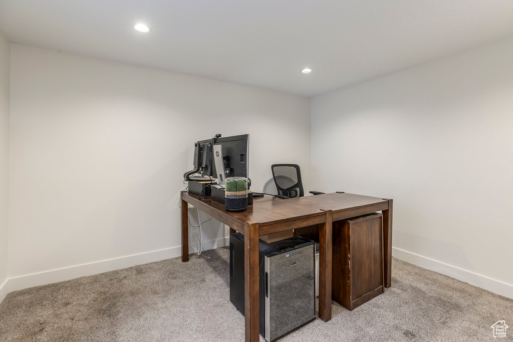 Home office with light colored carpet, baseboards, and recessed lighting