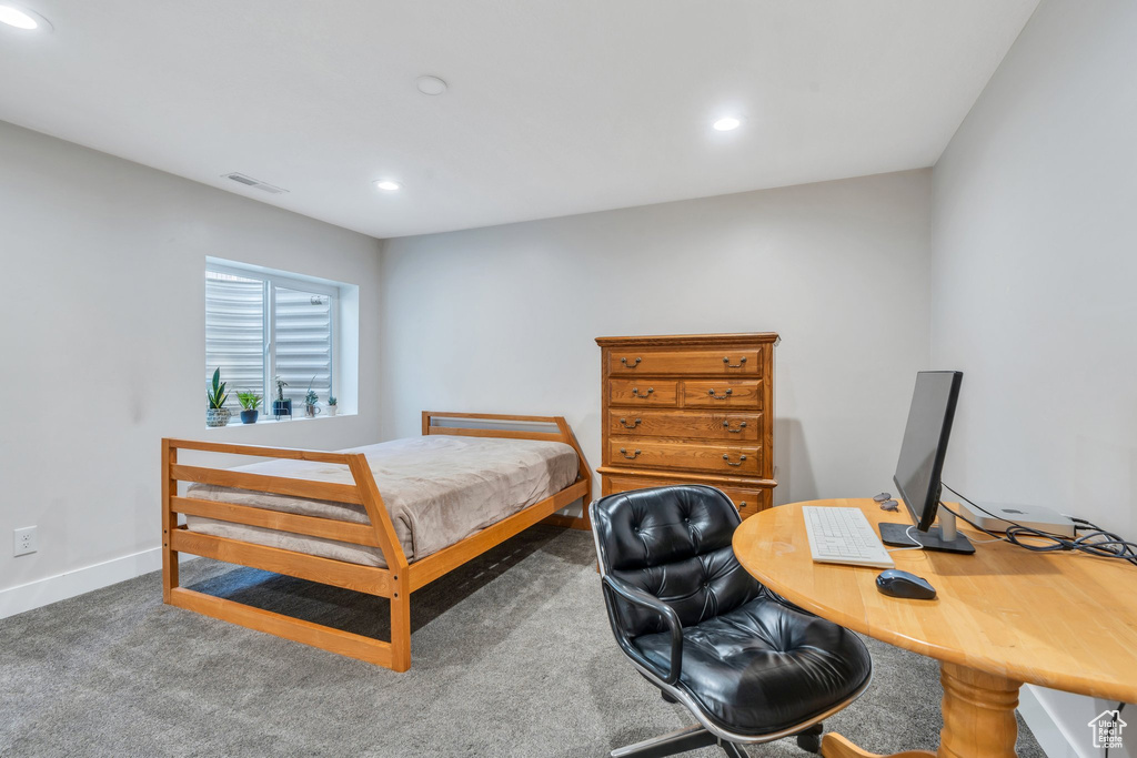 Carpeted bedroom with recessed lighting, baseboards, and an office area