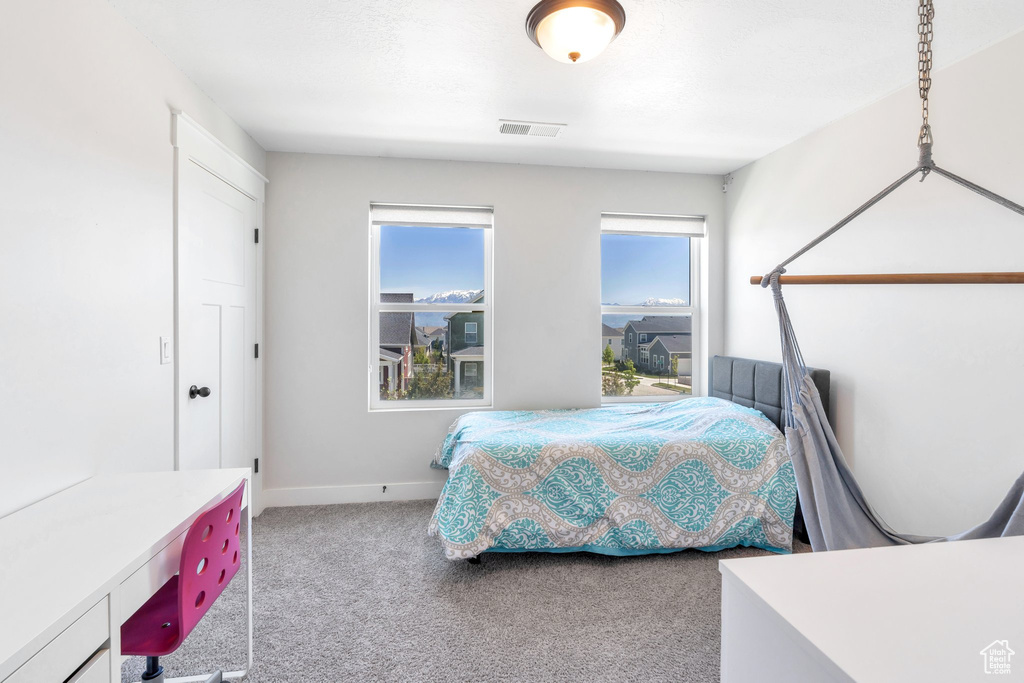 Bedroom featuring carpet flooring and baseboards