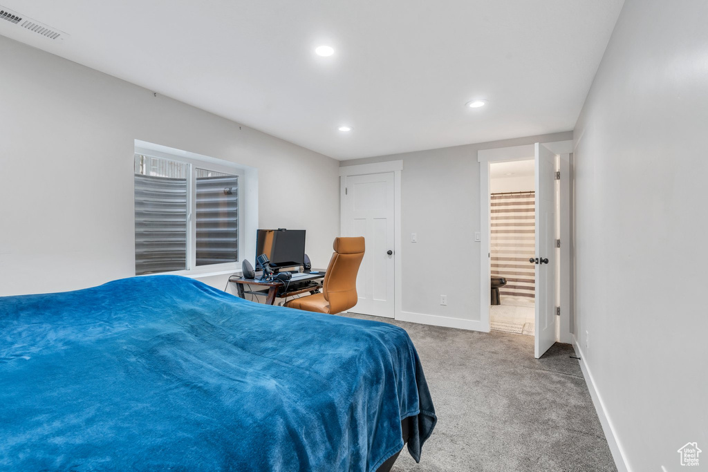 Carpeted bedroom with recessed lighting, baseboards, and a desk