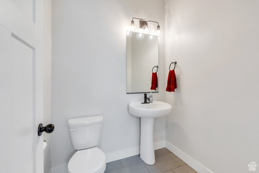 Bathroom with toilet and baseboards