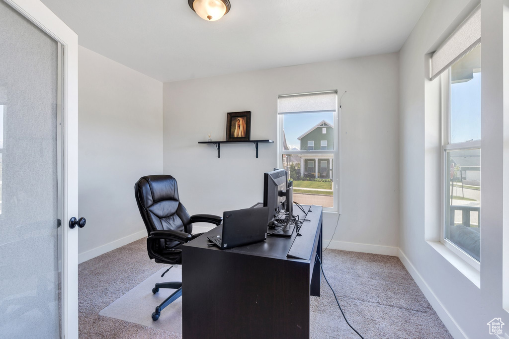 Carpeted office space with baseboards