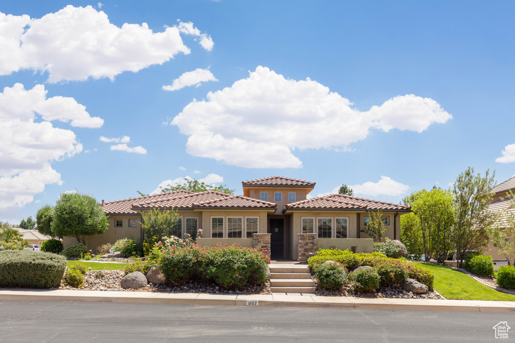 Mediterranean / spanish-style house featuring stucco siding and a tiled roof
