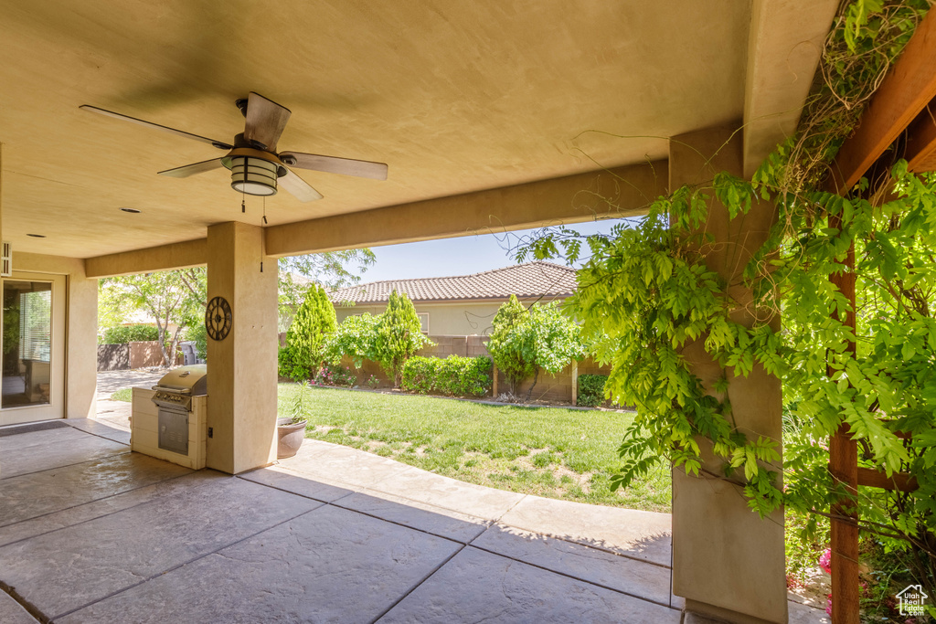 View of patio / terrace with a ceiling fan and exterior kitchen