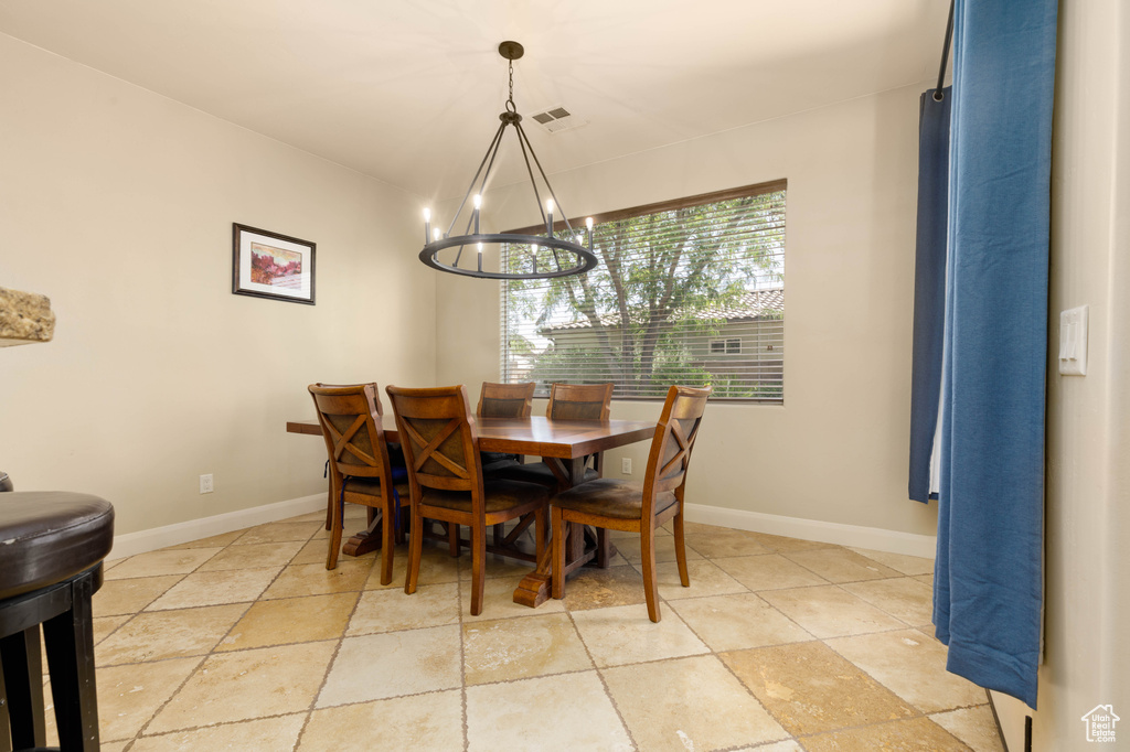 Dining room with a chandelier and baseboards