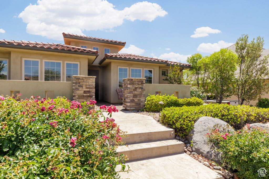 Mediterranean / spanish-style home featuring stucco siding and a tile roof