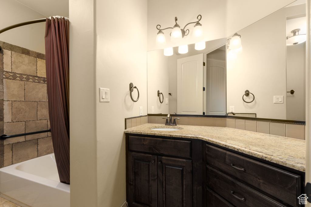 Full bath featuring shower / tub combo and vanity