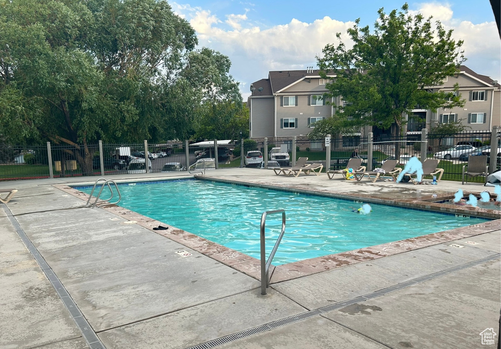 Community pool with a patio