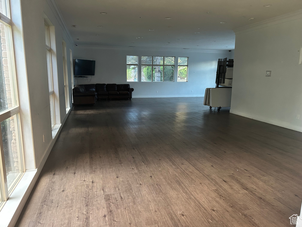 Living area featuring crown molding, wood finished floors, and baseboards