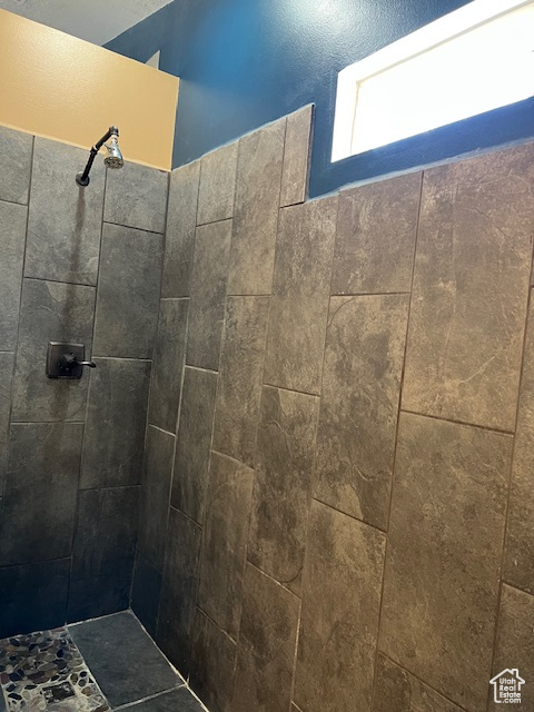 Full bath featuring a tile shower