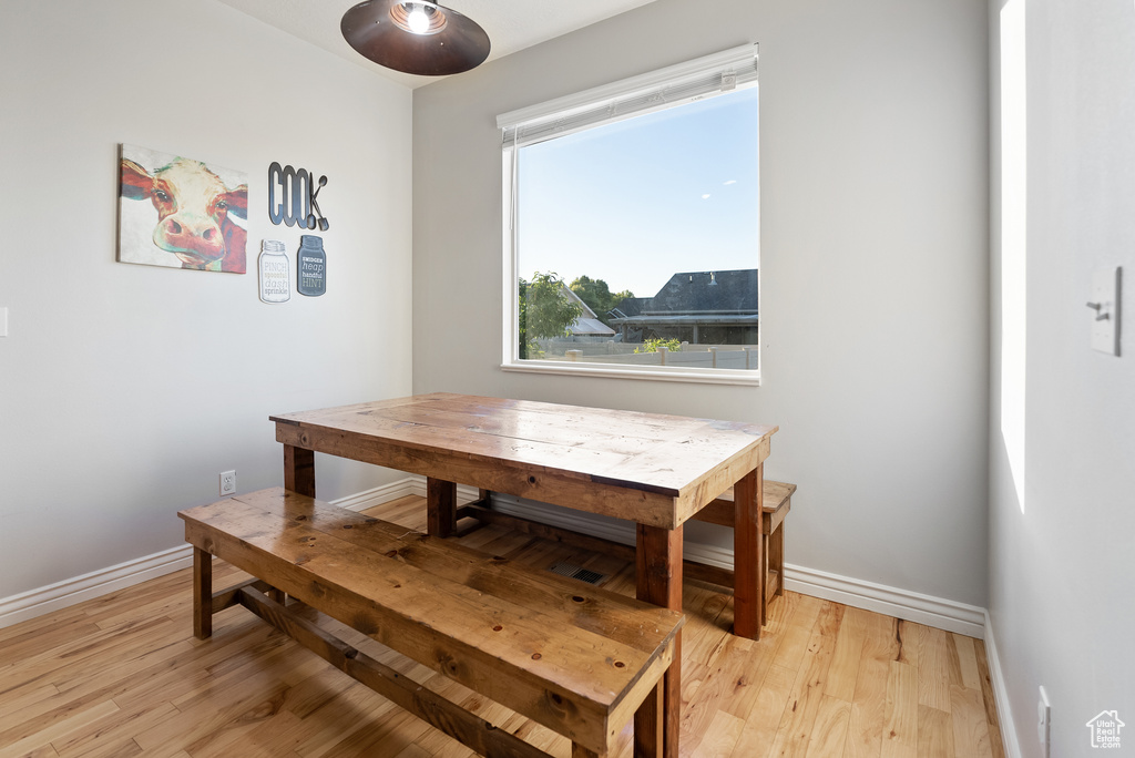 Dining area with light wood finished floors and baseboards