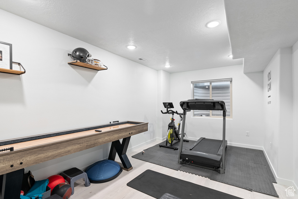 Exercise area with baseboards and recessed lighting