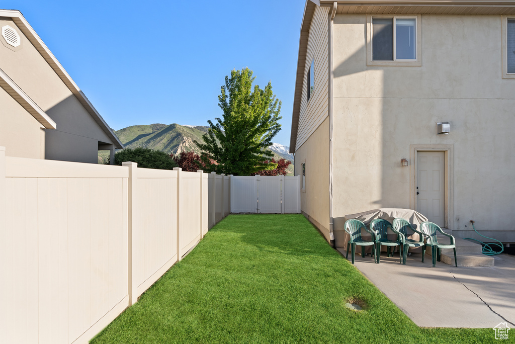 View of yard with a mountain view and a patio area