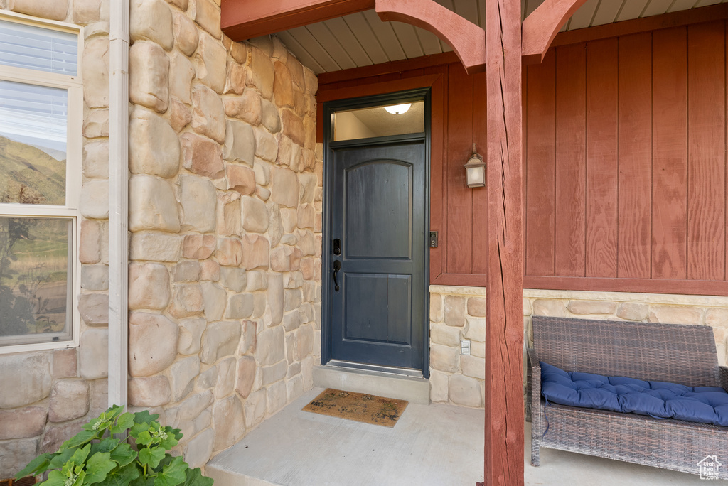 Doorway to property with stone siding