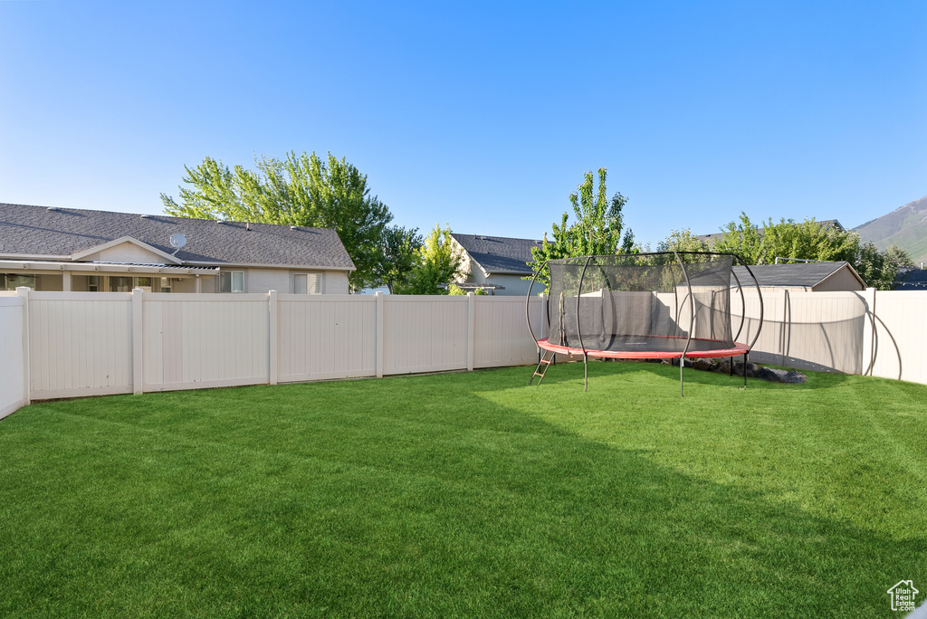 View of yard featuring a trampoline