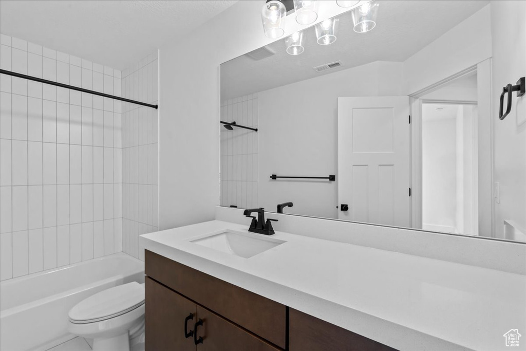 Full bathroom featuring vanity, toilet, and bathtub / shower combination