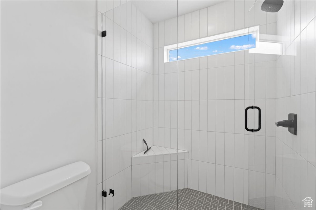 Bathroom with toilet and a stall shower