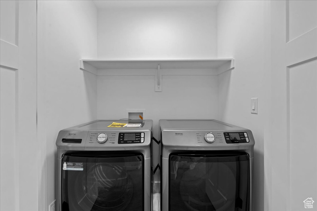 Laundry area featuring washing machine and clothes dryer
