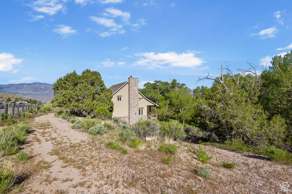 View of home's exterior with a chimney and a mountain view