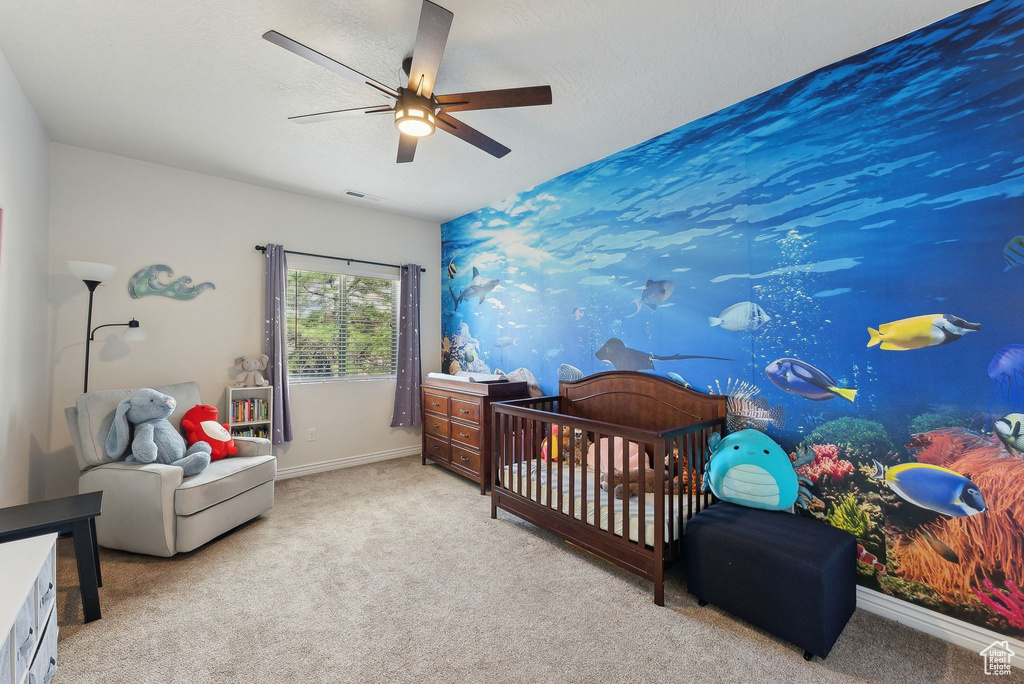Bedroom featuring carpet floors, baseboards, and a ceiling fan