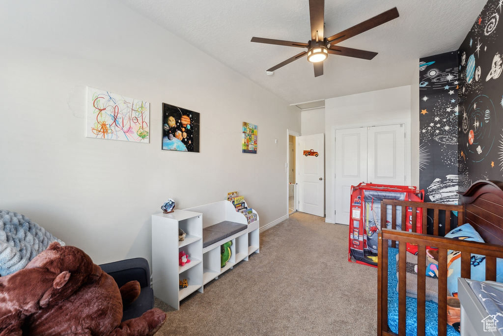 Carpeted bedroom with baseboards, ceiling fan, and a closet