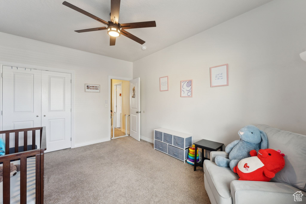 Carpeted bedroom featuring baseboards and ceiling fan