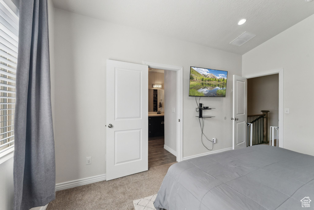 Carpeted bedroom featuring baseboards