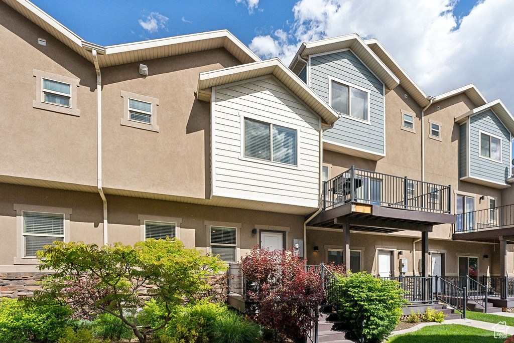 Rear view of property with stucco siding