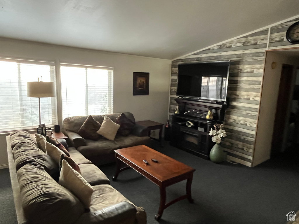 Living area featuring vaulted ceiling and carpet