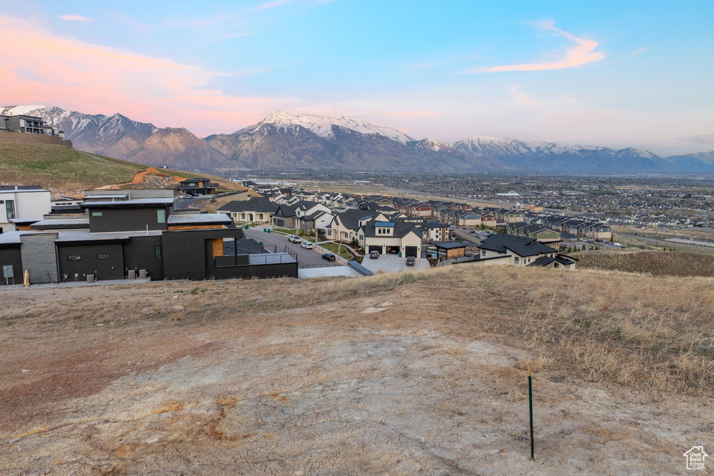 View of mountain backdrop featuring nearby suburban area