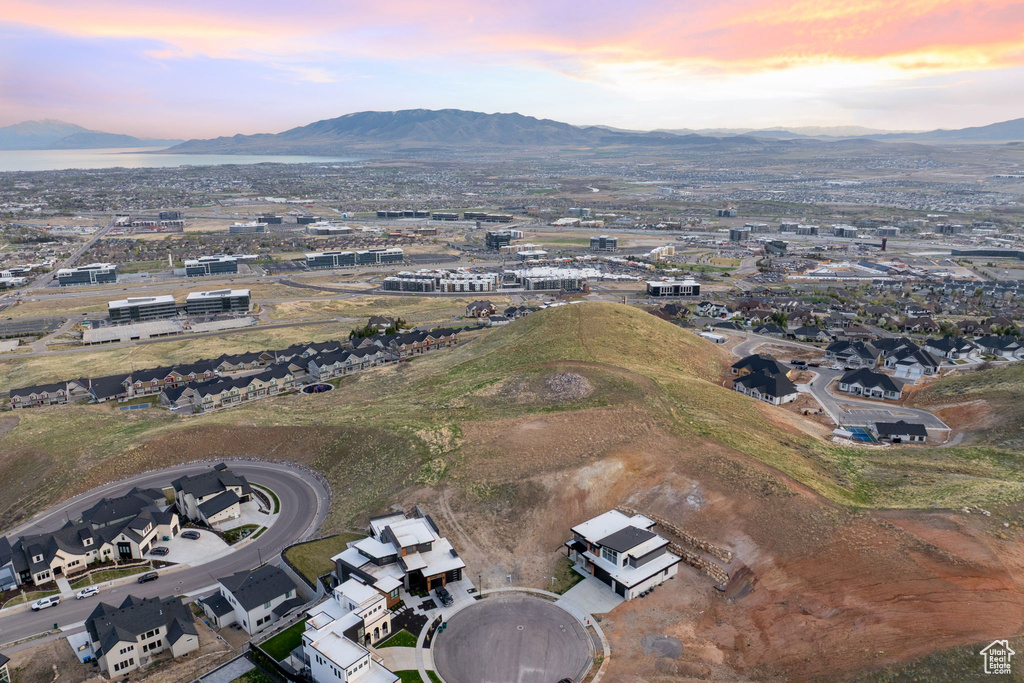 Aerial view of property and surrounding area featuring a mountainous background