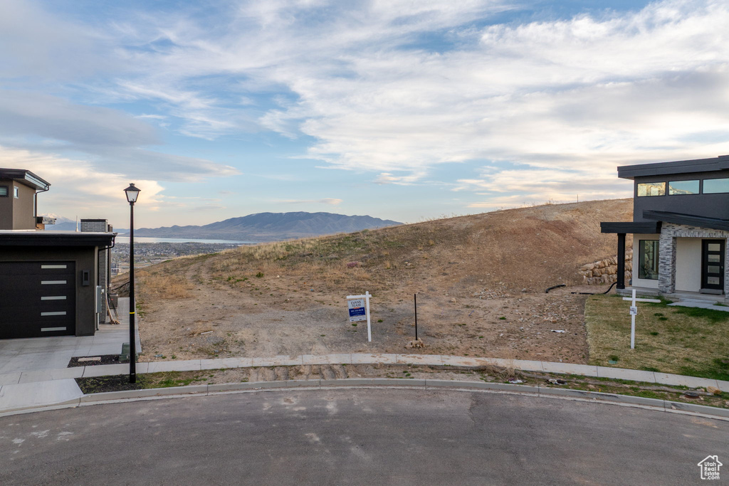 View of yard with a mountain view and driveway