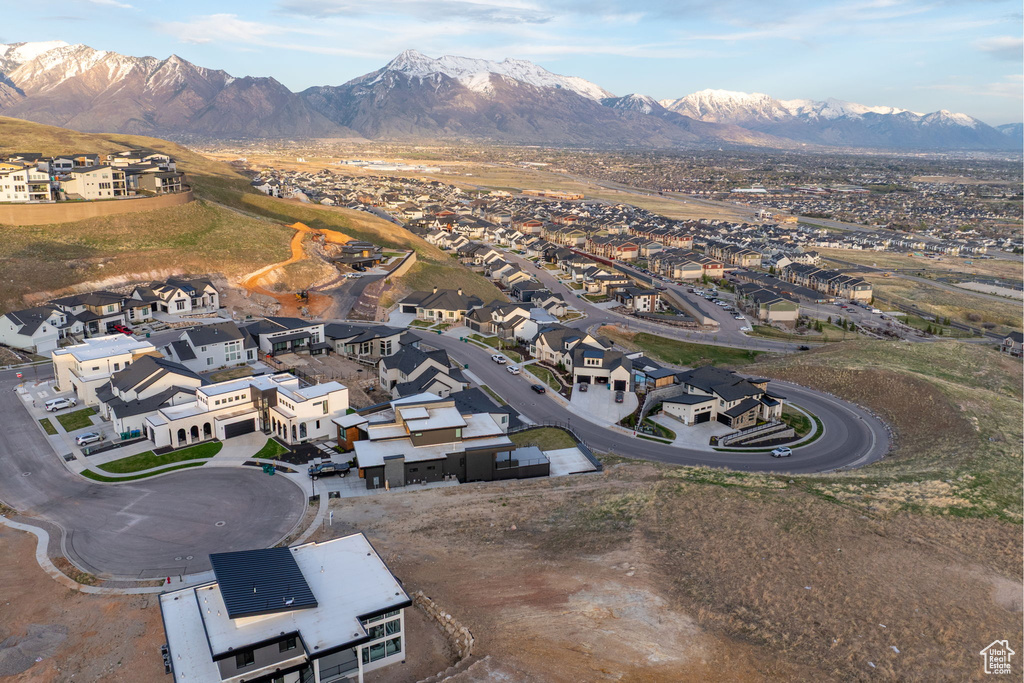 Aerial overview of property's location featuring a mountainous background and nearby suburban area