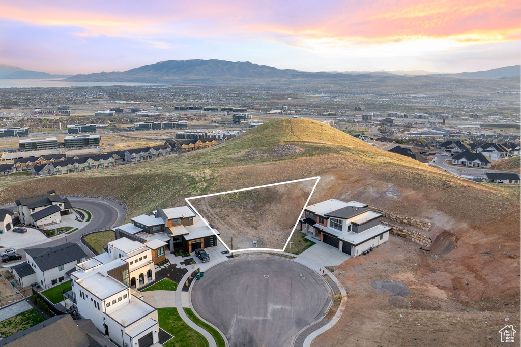 Aerial view of property and surrounding area featuring mountains and property parcel outlined