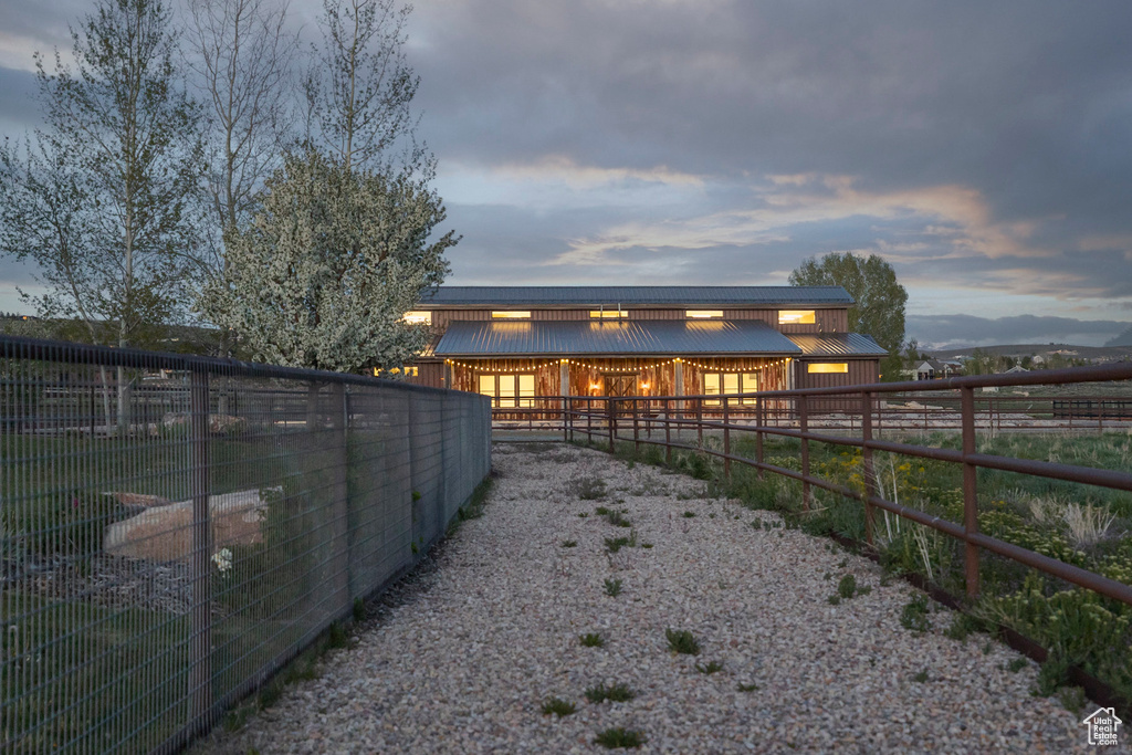 Rear view of house with an exterior structure, an outdoor structure, and metal roof