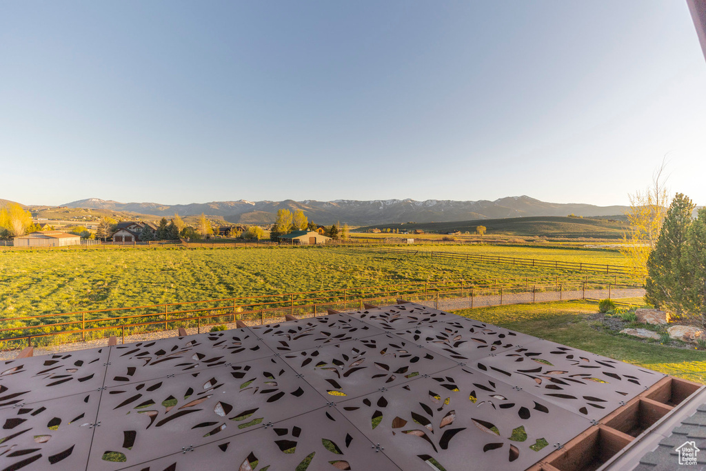 View of patio with a mountain view, a view of countryside, and agricultural area
