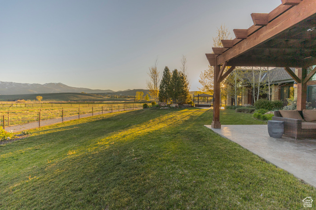 View of yard with a mountain view, a patio, and a pergola