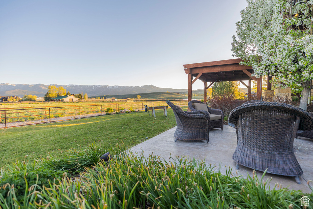View of patio featuring a mountain view, a gazebo, and a view of countryside