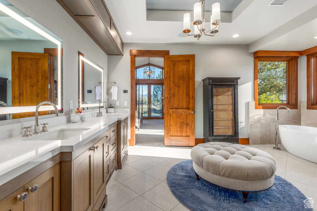 Bathroom with tile patterned flooring, double vanity, healthy amount of natural light, and recessed lighting