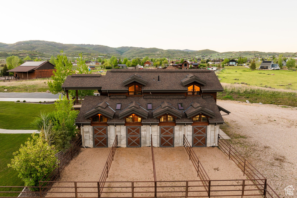 View of front of house with a mountain view, an exterior structure, an outdoor structure, and a barn