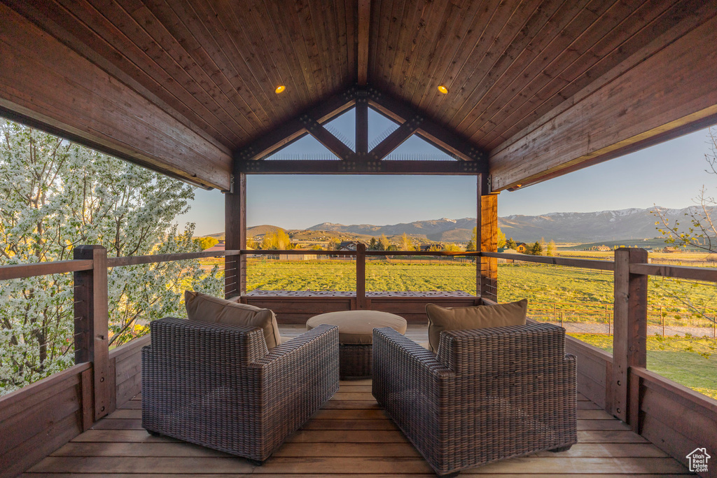 Wooden deck featuring a mountain view and a gazebo