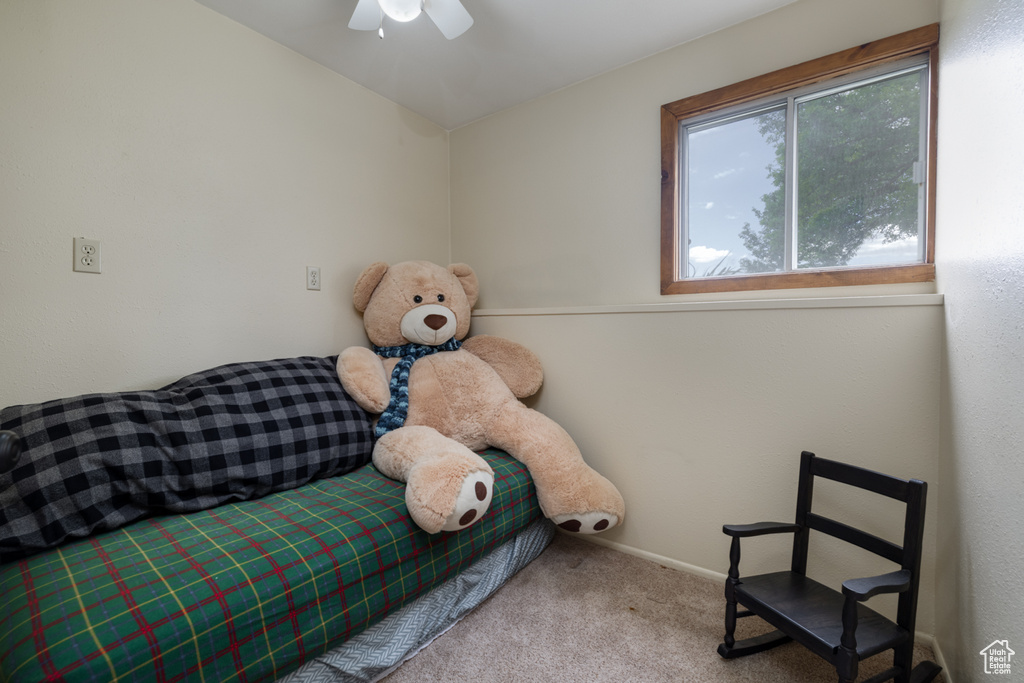 Sitting room with carpet floors, baseboards, and ceiling fan