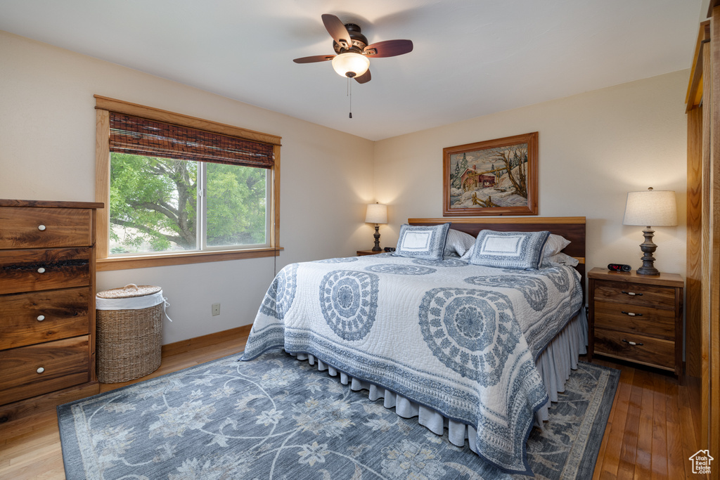 Bedroom with wood finished floors and ceiling fan