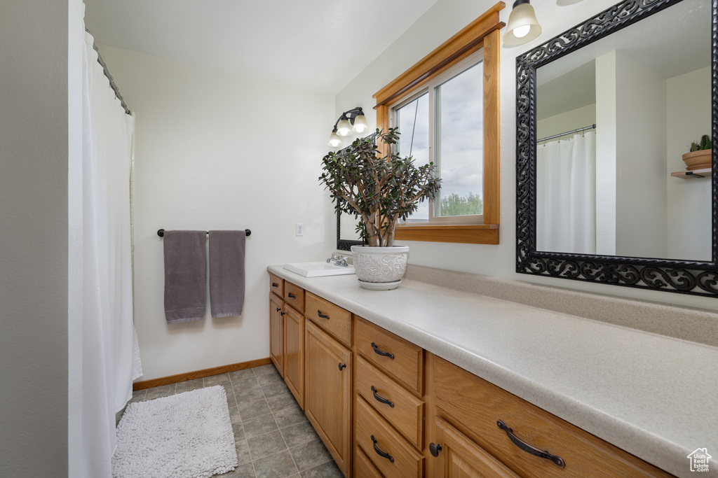 Bathroom featuring vanity and baseboards