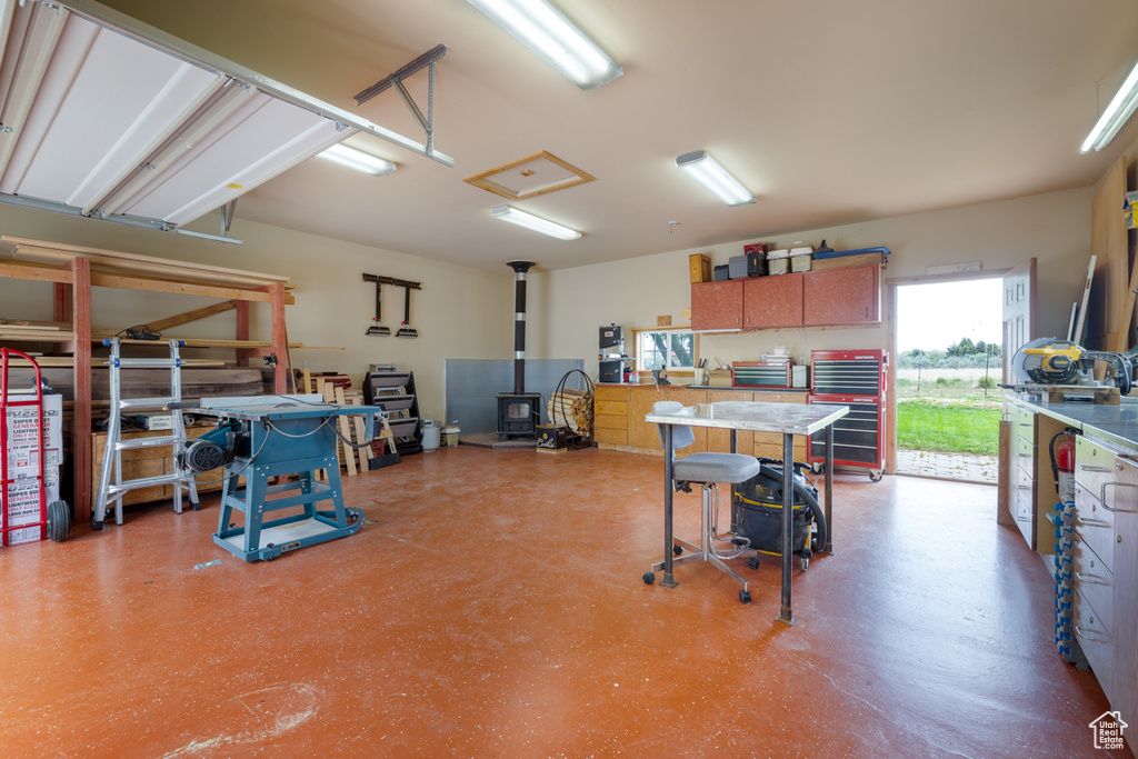 Garage with a wood stove and a workshop area