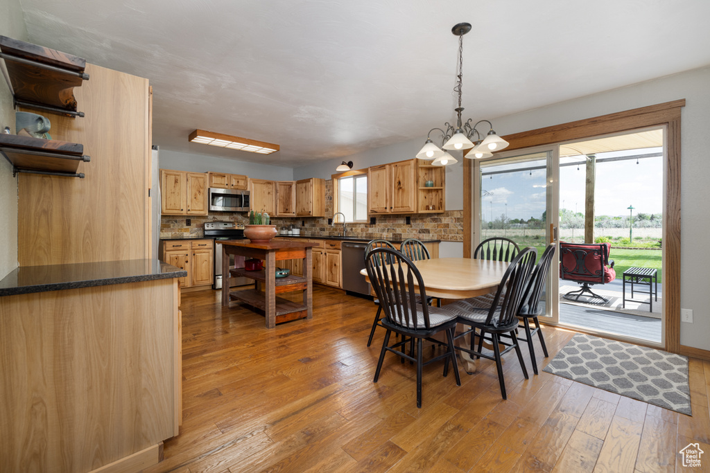 Dining room with hardwood / wood-style flooring and a chandelier