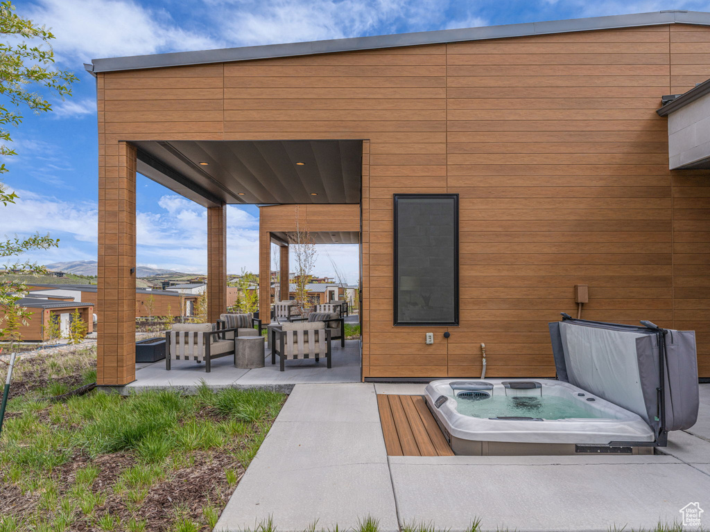 View of patio / terrace featuring a covered hot tub and an outdoor hangout area